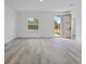 Light-filled living room with access to the entryway and contemporary flooring at 2436 Sw 155Th Ln, Ocala, FL 34473