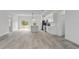 Open-concept living area with wood-look floors and abundant natural light at 2436 Sw 155Th Ln, Ocala, FL 34473