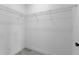 Empty walk-in closet features wire shelving and gray wood-look flooring at 2436 Sw 155Th Ln, Ocala, FL 34473