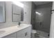 Updated bathroom boasts dual sinks, white cabinets, and an enclosed tiled shower at 245 Marion Oaks Golf Rd, Ocala, FL 34473