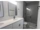 Modern bathroom boasts a dual sink vanity, quartz countertop, and walk-in glass shower at 245 Marion Oaks Golf Rd, Ocala, FL 34473