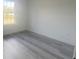 Bedroom with gray wood floors and a large window at 245 Marion Oaks Golf Rd, Ocala, FL 34473