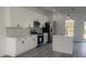 Modern kitchen featuring white cabinets, black hardware, stainless appliances and a center island with quartz countertops at 245 Marion Oaks Golf Rd, Ocala, FL 34473