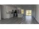 Modern kitchen featuring white cabinets, stainless appliances, a center island, and sliding glass doors to the backyard at 245 Marion Oaks Golf Rd, Ocala, FL 34473