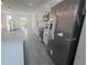 Bright kitchen showcases stainless steel appliances, white cabinets, and a spacious island with a breakfast bar at 245 Marion Oaks Golf Rd, Ocala, FL 34473
