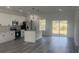 Modern kitchen featuring white cabinets, stainless appliances, a center island, and sliding glass doors to the backyard at 245 Marion Oaks Golf Rd, Ocala, FL 34473
