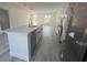 Kitchen island featuring a sink and dishwasher with seating, stone countertop, and view of open concept living area at 245 Marion Oaks Golf Rd, Ocala, FL 34473