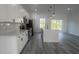 Modern kitchen featuring white cabinets, stainless appliances, a center island, and sliding glass doors to the backyard at 245 Marion Oaks Golf Rd, Ocala, FL 34473