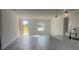 Open concept living room with open front door and kitchen area at 245 Marion Oaks Golf Rd, Ocala, FL 34473