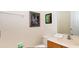 Well-lit half bathroom with a vanity, toilet, and decorative artwork at 3008 Secret Lake Dr, Kissimmee, FL 34747