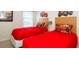 themed bedroom with two twin beds, race car decor, and bright red bedding at 3008 Secret Lake Dr, Kissimmee, FL 34747