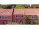 Townhomes with terra cotta tile roofs, colorful facades and tropical landscaping provide a lovely curb appeal at 3008 Secret Lake Dr, Kissimmee, FL 34747