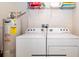 Laundry room featuring washer, dryer, and water heater at 3008 Secret Lake Dr, Kissimmee, FL 34747