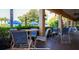 Outdoor patio with outdoor dining tables and blue chairs at 3008 Secret Lake Dr, Kissimmee, FL 34747