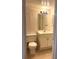 Bathroom featuring a toilet, sink, vanity with doors, mirror, and lighting at 3071 George Mason Ave # A, Winter Park, FL 32792