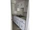 Kitchen with white cabinets, double sink, light countertop, and white appliances at 3071 George Mason Ave # A, Winter Park, FL 32792