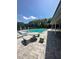 Community pool area with lounge chairs, stone table and benches, and shaded pavilion at 3071 George Mason Ave # A, Winter Park, FL 32792