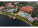 Aerial view showcases the community clubhouse, pools, and the lake at 3154 Yellow Lantana Ln, Kissimmee, FL 34747