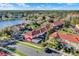 Aerial view of multi-Gathering homes by the lake, featuring private screened in patios with a backdrop of lush greenery at 3154 Yellow Lantana Ln, Kissimmee, FL 34747