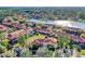 Aerial view showcases the community, highlighting the lake, townhomes, mature landscaping, and convenient parking at 3154 Yellow Lantana Ln, Kissimmee, FL 34747