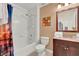 Clean bathroom featuring a shower-tub combo, vanity with granite countertop, and colorful city themed shower curtain at 3154 Yellow Lantana Ln, Kissimmee, FL 34747