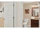 Well-maintained bathroom featuring a toilet, vanity with granite countertop, and decorative wall art at 3154 Yellow Lantana Ln, Kissimmee, FL 34747