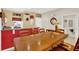 Open dining area with natural light, wood table, and seating at 3154 Yellow Lantana Ln, Kissimmee, FL 34747