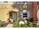 Home exterior featuring a decorative front door, landscaped yard, and well-maintained facade at 3154 Yellow Lantana Ln, Kissimmee, FL 34747