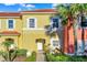 Charming townhome featuring a private entrance, well-maintained landscaping, and a vibrant, colorful facade at 3154 Yellow Lantana Ln, Kissimmee, FL 34747