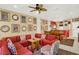Inviting living room features a large sectional, ceiling fan, and bright lighting at 3154 Yellow Lantana Ln, Kissimmee, FL 34747