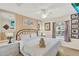 Bright main bedroom with a ceiling fan, natural lighting, and decorative accents at 3154 Yellow Lantana Ln, Kissimmee, FL 34747