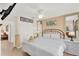 Main bedroom with neutral tones, ceiling fan, and large bed at 3154 Yellow Lantana Ln, Kissimmee, FL 34747
