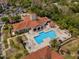 Aerial view of community pool with lounge chairs, cabanas, and well-maintained landscaping at 3154 Yellow Lantana Ln, Kissimmee, FL 34747