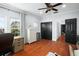 Bedroom featuring wood floors, ample closet space, and natural light at 3308 Middlesex Rd, Orlando, FL 32803