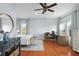 Spacious bedroom with hardwood floors, desk, ceiling fan, and natural light at 3308 Middlesex Rd, Orlando, FL 32803