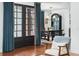 Bright dining area with elegant lighting, stylish drapery, and French doors leading to outdoor spaces at 3308 Middlesex Rd, Orlando, FL 32803