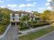 Stunning two-story home featuring lush landscaping, a tile roof, and an attached two-car garage with a concrete driveway at 3308 Middlesex Rd, Orlando, FL 32803