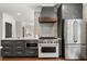 Modern kitchen featuring stainless steel appliances, custom cabinetry, and an elegant range hood at 3308 Middlesex Rd, Orlando, FL 32803