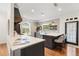 Bright kitchen featuring quartz countertops, an island with seating, designer wallpaper and stainless steel appliances at 3308 Middlesex Rd, Orlando, FL 32803