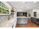 Modern kitchen features a farmhouse sink, decorative tile, and stylish island with wood floors at 3308 Middlesex Rd, Orlando, FL 32803