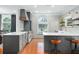 Bright kitchen featuring custom cabinets, stainless appliances, and stylish wallpaper at 3308 Middlesex Rd, Orlando, FL 32803