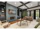 Bright and airy living room boasts hardwood floors, beamed ceilings, custom built-ins, and a cozy stone fireplace at 3308 Middlesex Rd, Orlando, FL 32803
