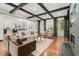 Bright living room featuring hardwood floors, wooden beams, and stylish furniture at 3308 Middlesex Rd, Orlando, FL 32803