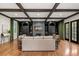 Spacious living room with beamed ceilings, custom built-ins, fireplace, hardwood floors and ample seating at 3308 Middlesex Rd, Orlando, FL 32803