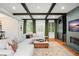 Bright living room featuring hardwood floors, coffered ceilings, and a fireplace at 3308 Middlesex Rd, Orlando, FL 32803