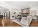 Cozy living room with stone fireplace, neutral furniture, and hardwood floors at 3308 Middlesex Rd, Orlando, FL 32803
