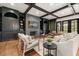 Well-appointed living room featuring hardwood floors, beamed ceilings, custom built-ins, and a cozy fireplace at 3308 Middlesex Rd, Orlando, FL 32803