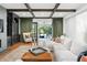 Cozy living room featuring hardwood floors, custom shelving, and access to the patio at 3308 Middlesex Rd, Orlando, FL 32803