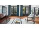 Comfortable living room featuring French doors, hardwood floors, stylish decor, and abundant natural light at 3308 Middlesex Rd, Orlando, FL 32803