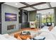 Elegant living room boasts a stone fireplace, built-in shelving, hardwood floors, and beamed ceilings at 3308 Middlesex Rd, Orlando, FL 32803